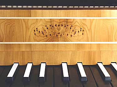 A view of the animal head on the nameboard formed by patterns in the yew veneer